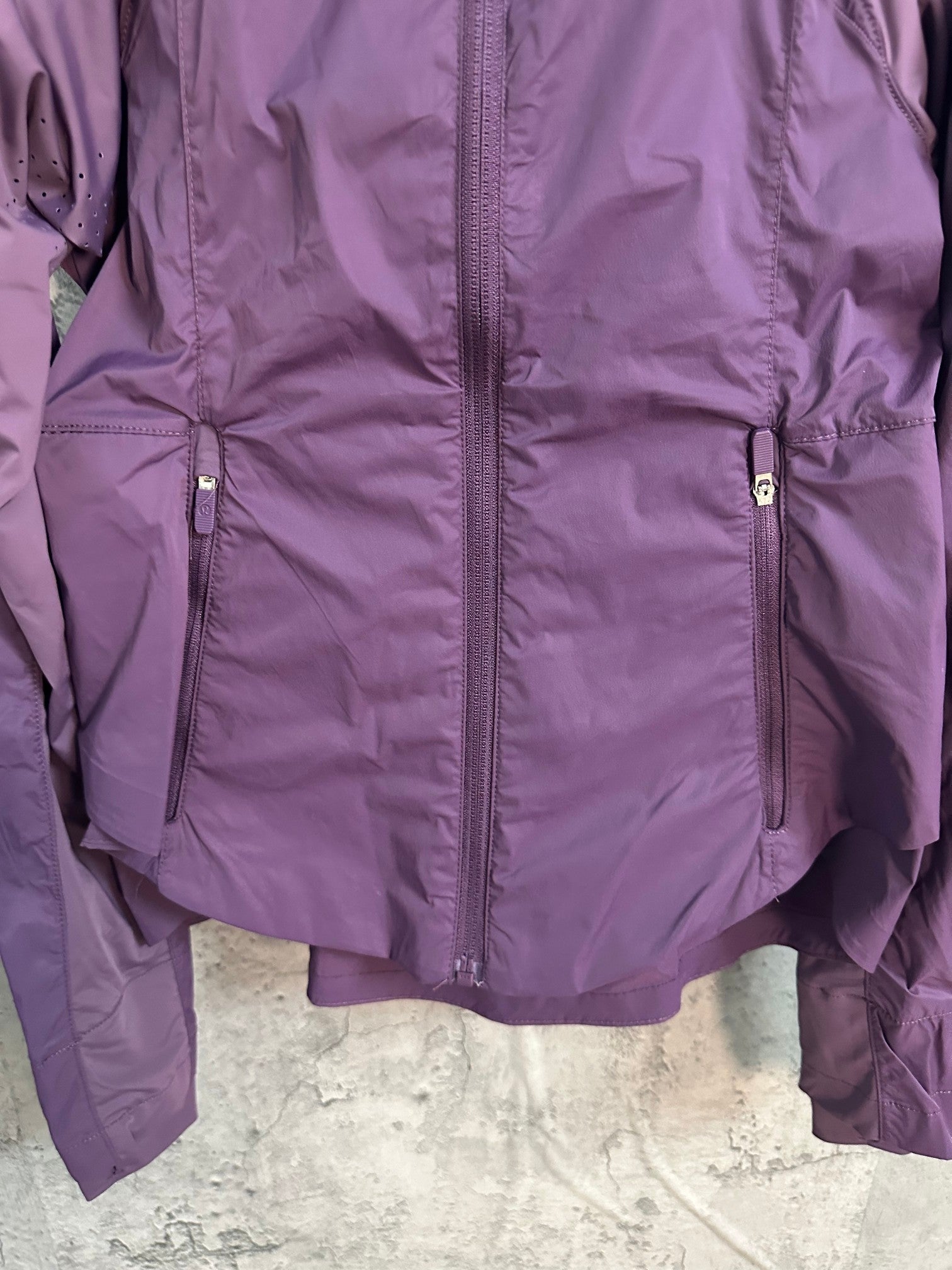 Purple windbreaker jacket with center zipper and two chest pockets