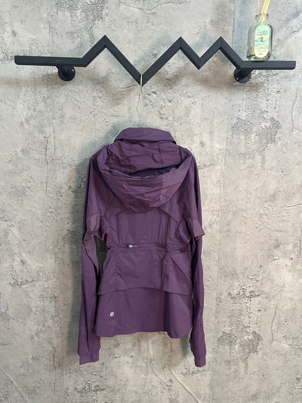 Purple hooded windbreaker jacket with full zip and adjustable back panel