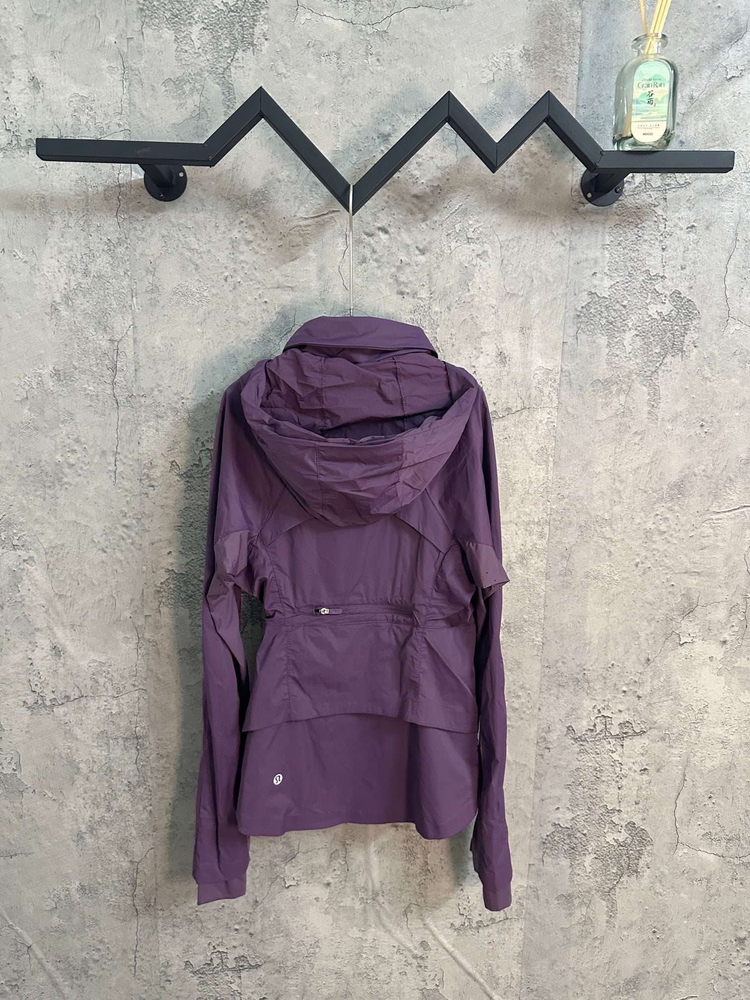 Purple hooded windbreaker jacket with full zip and adjustable back panel