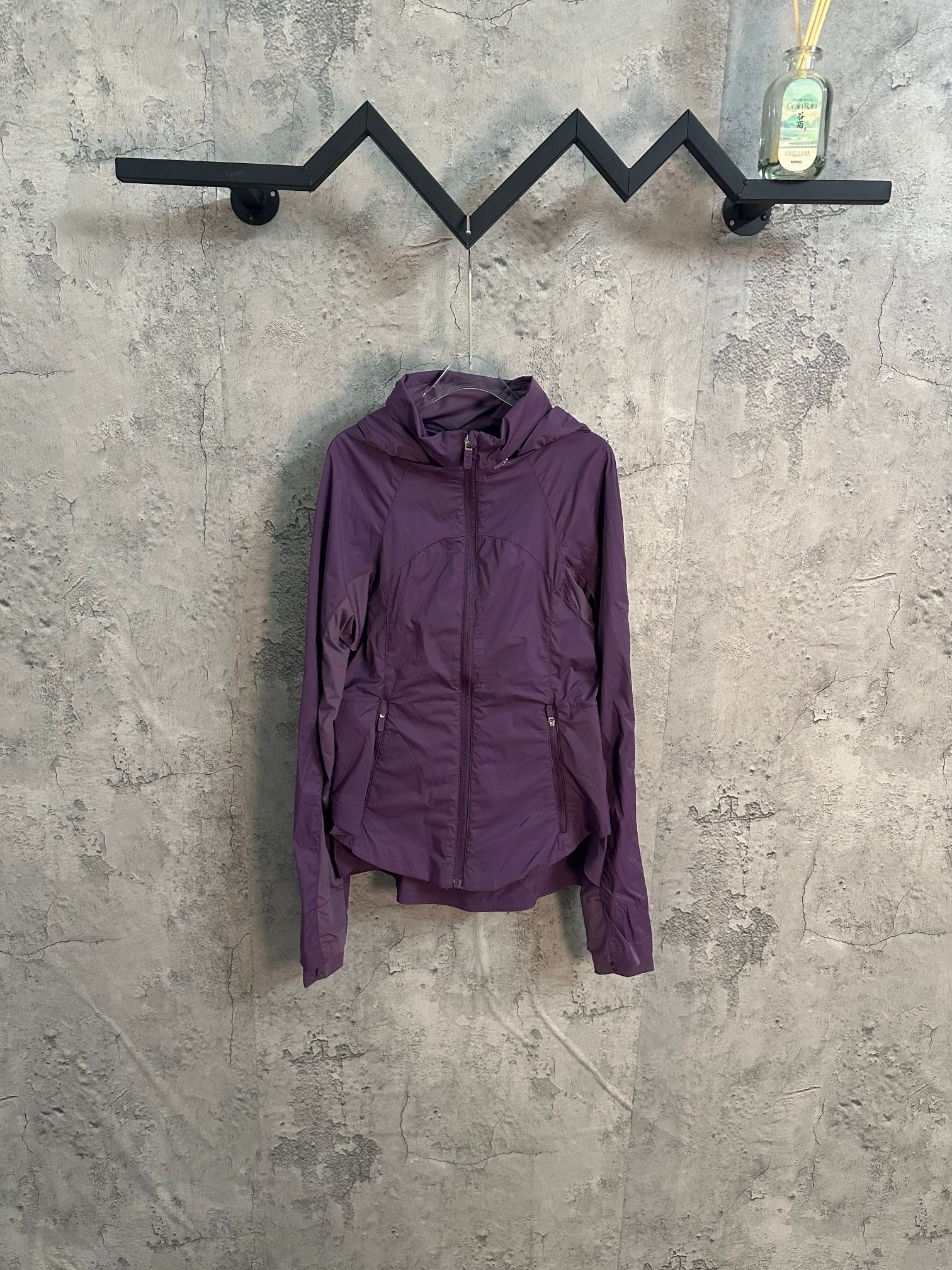 Purple hooded windbreaker jacket with front zipper and drawstring waist