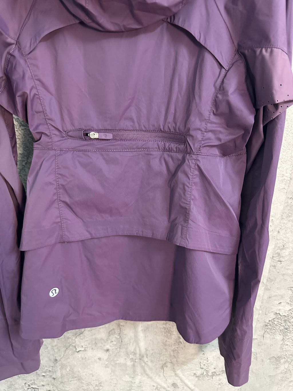 Purple windbreaker jacket interior view with drawcord waist