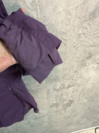 Purple windbreaker jacket sleeve and front pocket with zipper