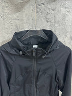 Hooded rain jacket chest close-up with front zipper and drawcord hood, dark color