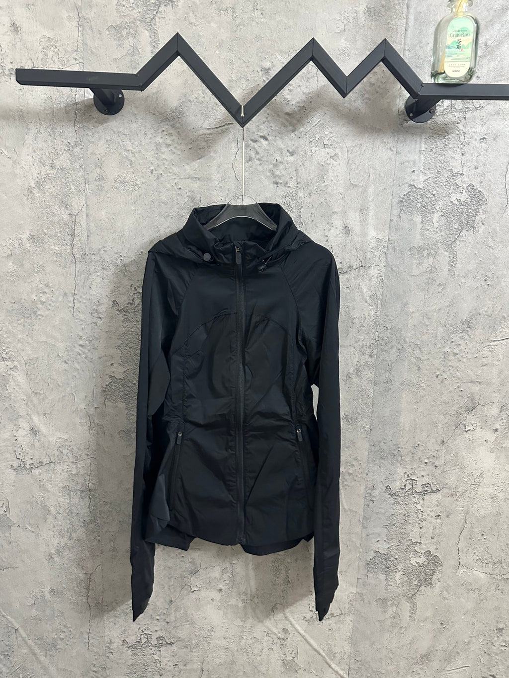 Hooded rain jacket with full front zipper and stand collar, dark color, long sleeves