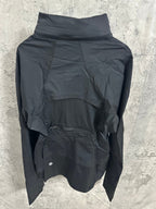 Hooded rain jacket back view with high collar and layered hood, dark color