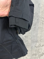 Hooded rain jacket cuff and hem close-up, dark color, elastic cuff detail