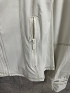 White zip front with exposed zipper and vertical pocket seam detail