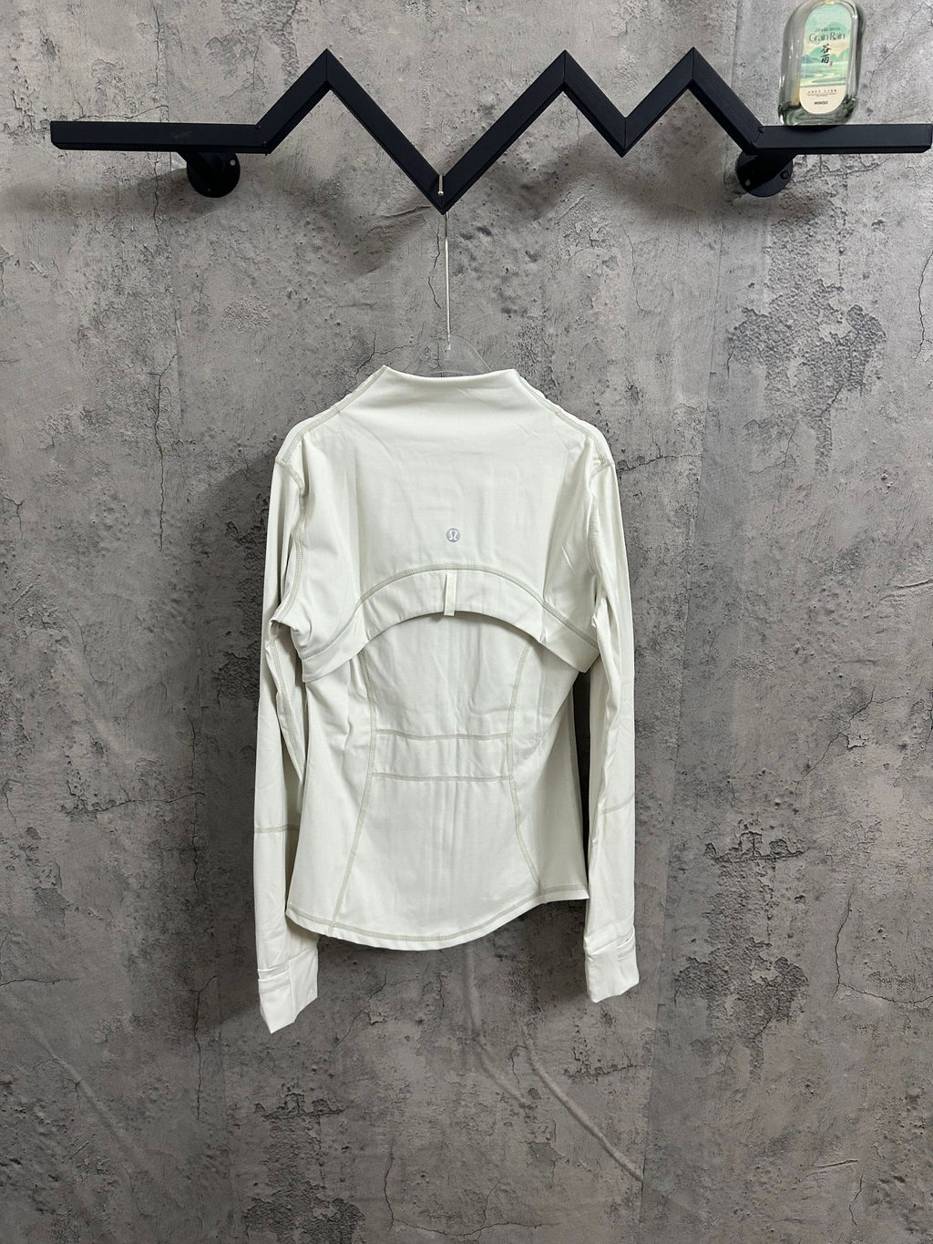 White jacket front view with high neck and long sleeves, seam details