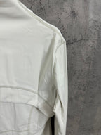 White jacket shoulder with textured seam trim and curved panel stitching
