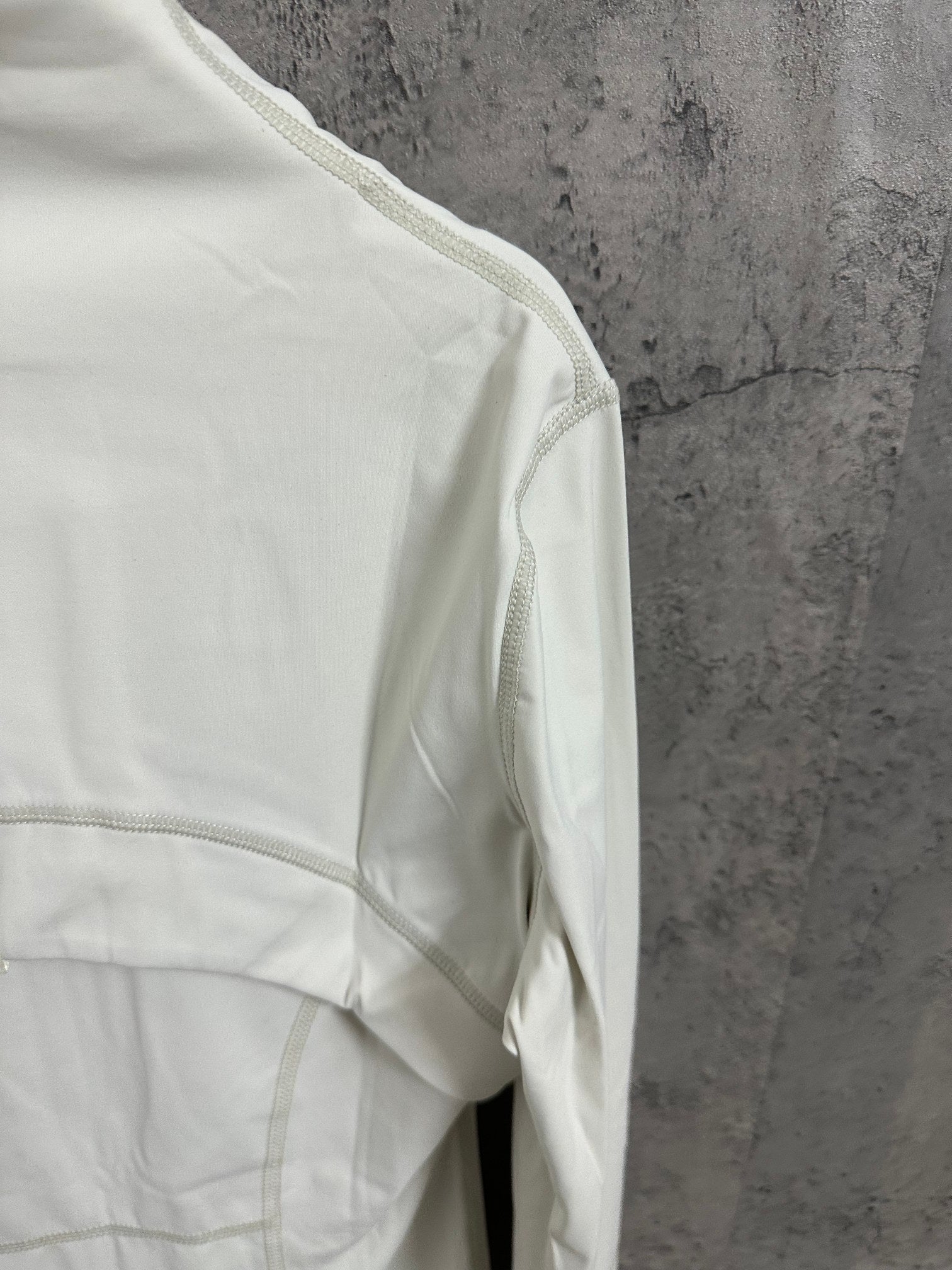 White jacket side panel with diagonal seam and textured trim piping