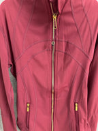 Burgundy jacket front close-up with gold zipper and contrast stitch lines