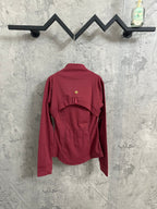 Burgundy jacket with back yoke detail and small gold emblem on upper back