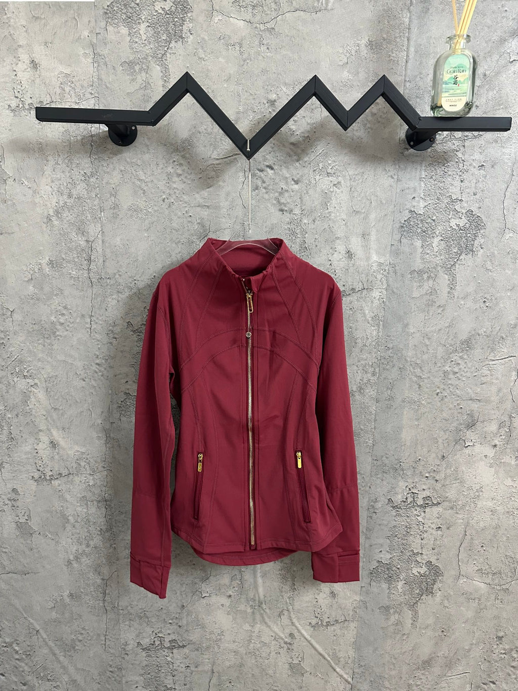 Burgundy zip-front jacket with stand collar and two zip pockets
