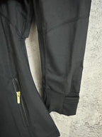 Black jacket with ribbed cuffs and partial side zipper pocket