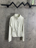 Light white zip-up jacket with stand collar, gold front zipper, and side zip pockets.