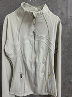 Light white zip-up jacket with stand collar, gold zipper pulls, and curved panel stitching.