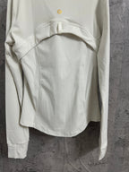 Light white zip-up jacket back view with waist seam shape and small gold logo at upper back.
