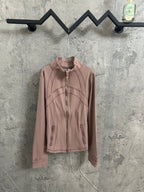 Zip-front jacket in dusty pink with stand collar and contrast seam piping