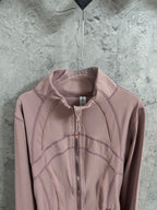 Dusty pink zip-up jacket with raised seams and stand collar