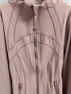 Dusty pink jacket front with central zipper and curved contrast stitch lines