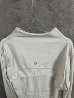 White zip-up jacket back view with small gold logo and curved yoke seam