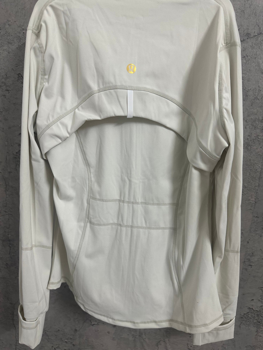 White zip-up jacket back view, stand collar and curved hem seams