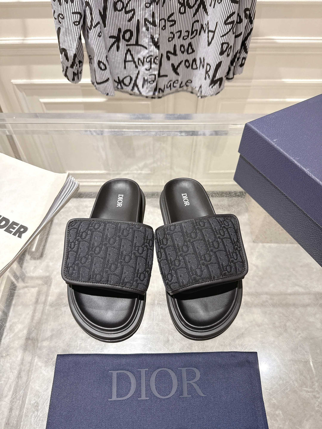 Black Dior slide sandals with textured monogram strap and cushioned footbed