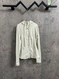 White zip-up hooded jacket with full front zipper, hanging on a rack.