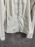 White zip-up hooded jacket front close-up with full zipper and drawstring pulls.