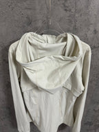 Cream hooded jacket back view with draped hood and long sleeves