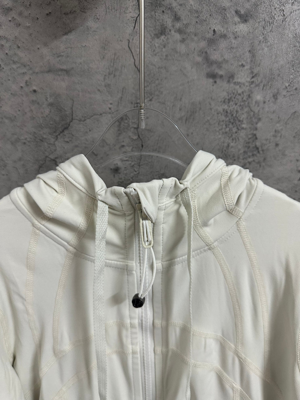 Cream hood with adjustable drawstrings and cord tips
