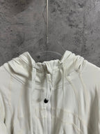 Cream hood with adjustable drawstrings and cord tips