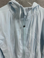 Light blue zip-up jacket close-up with hood and drawcord with dark toggle