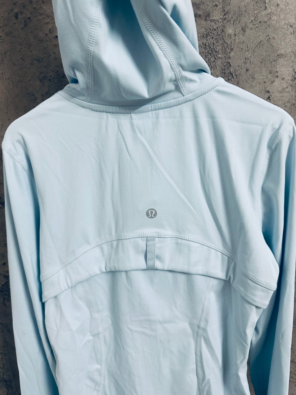 Light blue hooded zip jacket back with small logo at upper back