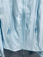 Light blue jacket front with triple zippers and metal pulls