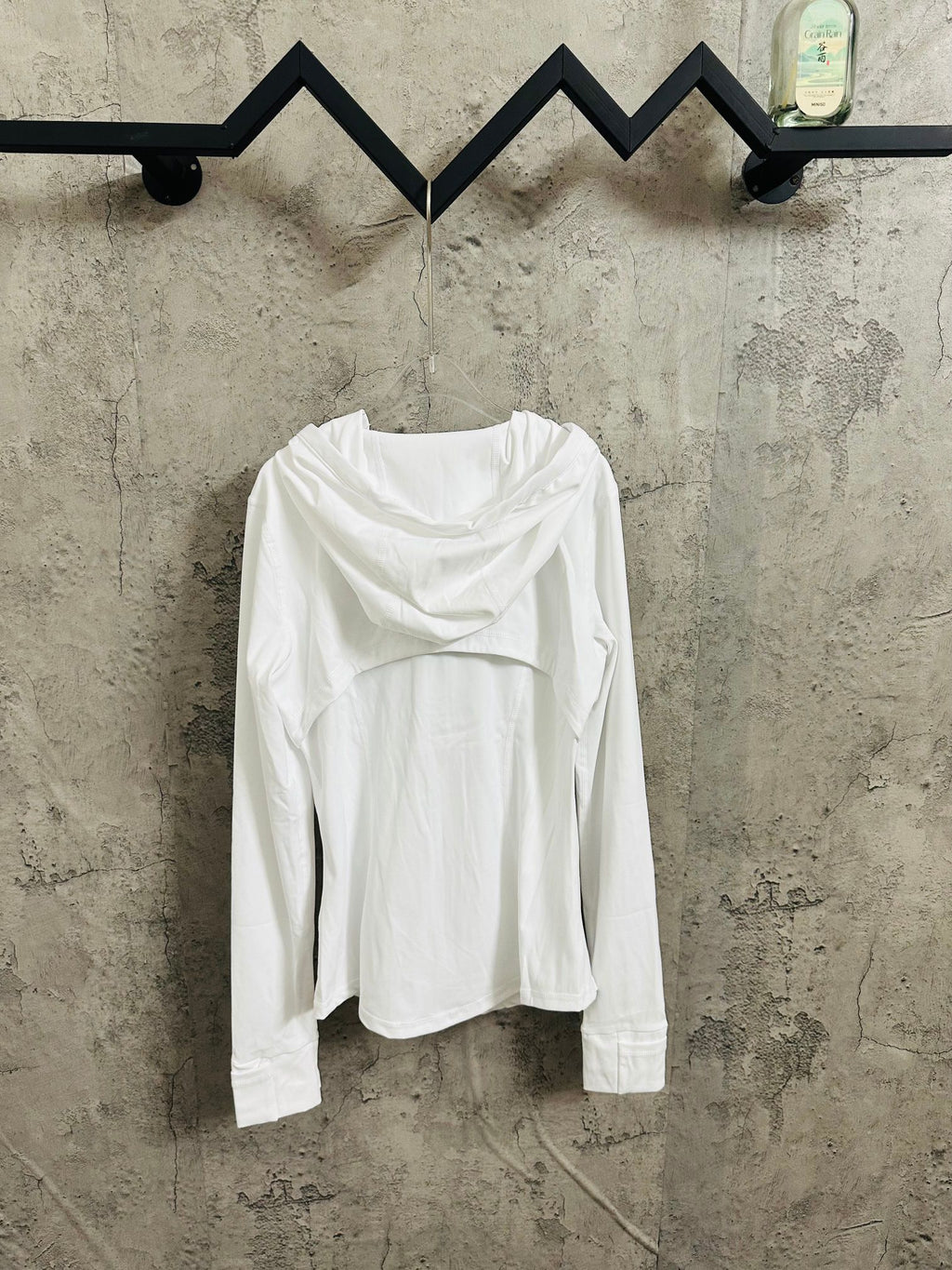 White hooded jacket worn with hood down, full front zip and long sleeves