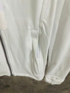 White jacket close-up of drawstring hem and pocket seam details