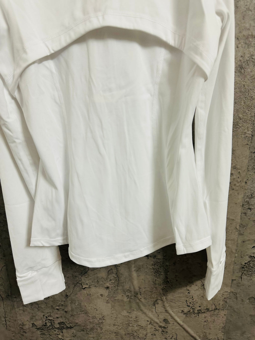 White jacket back close-up with arched seam at upper yoke