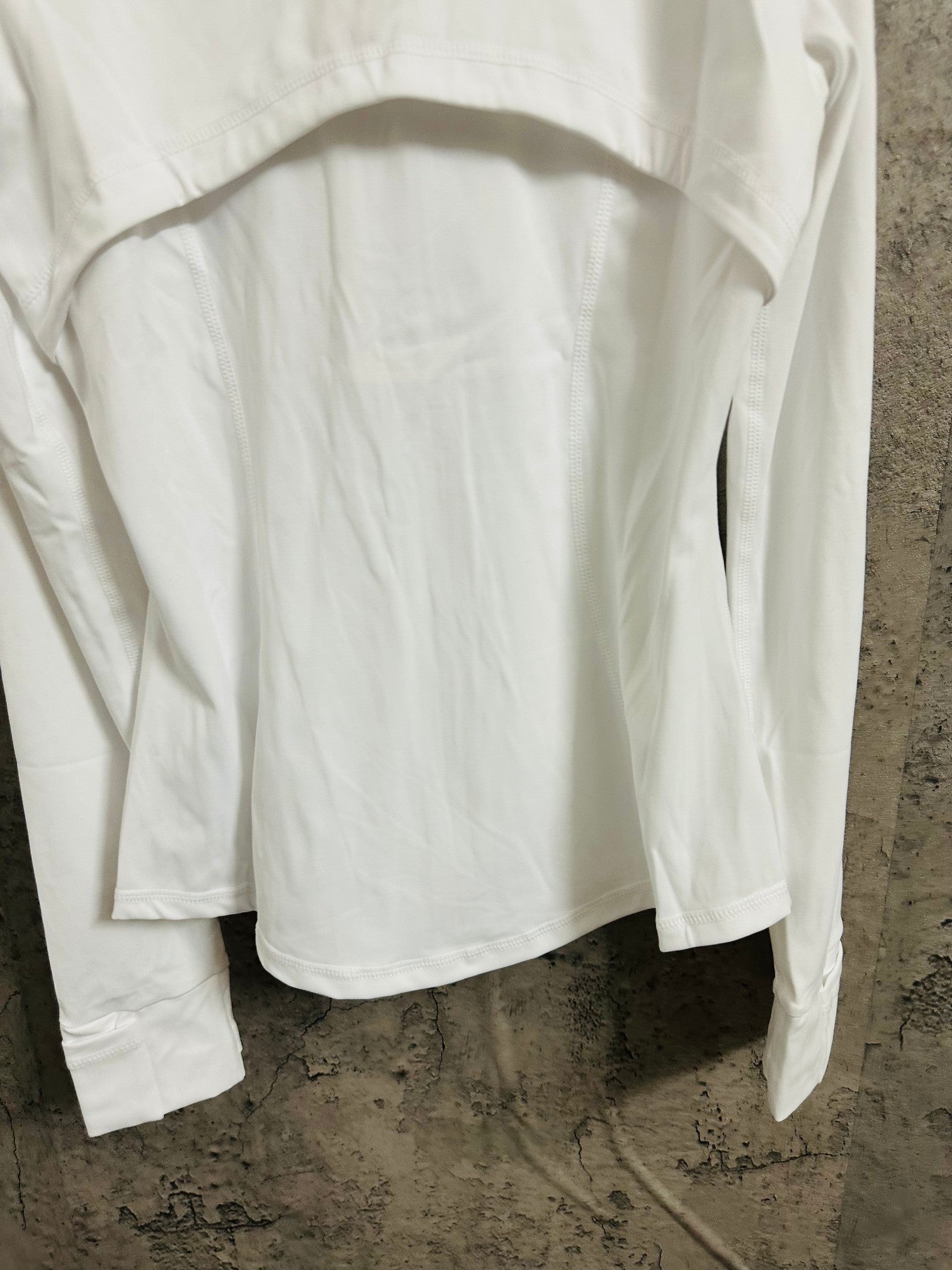 White jacket back close-up with arched seam at upper yoke