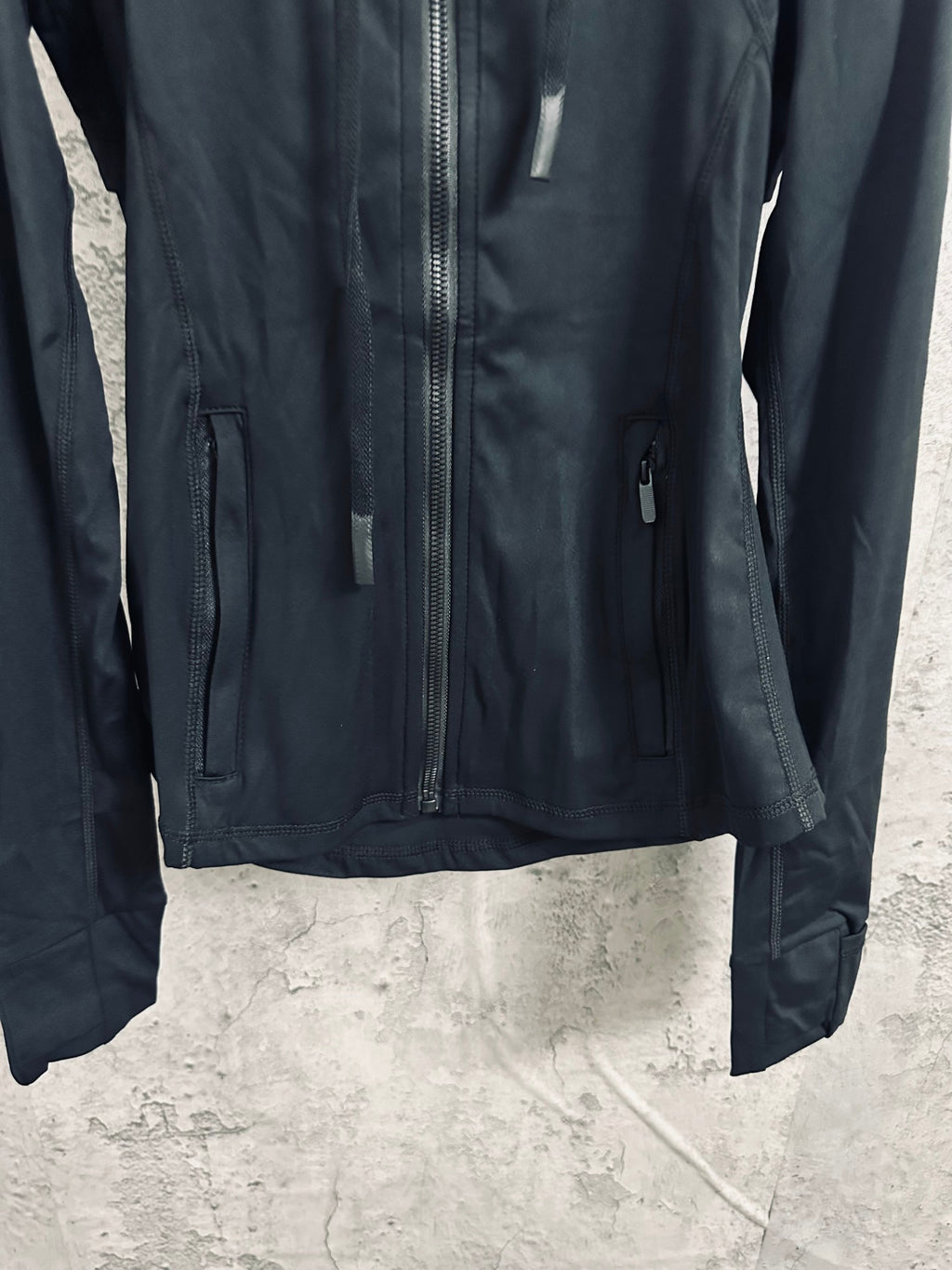 Dark hooded zip jacket with chest zipper and side pockets