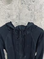 Dark hooded jacket with drawstring hood and full-length zipper