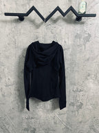 Dark hooded jacket with asymmetrical drape and long sleeves