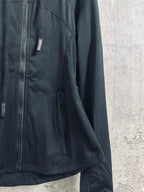 Dark zip jacket with side pocket, seam stitching, and long sleeves