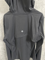 Dark hooded jacket back with small chest logo and curved yoke seam