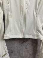 Light cream ribbed jacket front with full zipper and stitched curved yoke seam