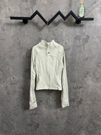 Light cream ribbed jacket with full front zipper, high stand collar, and chest logo