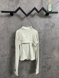 Light cream ribbed high-neck jacket with curved yoke seam and small chest logo