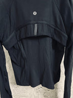 Dark jacket close-up showing upper yoke seam and back panel contour