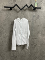 White hooded zip-up jacket with long sleeves, hanging on a hanger