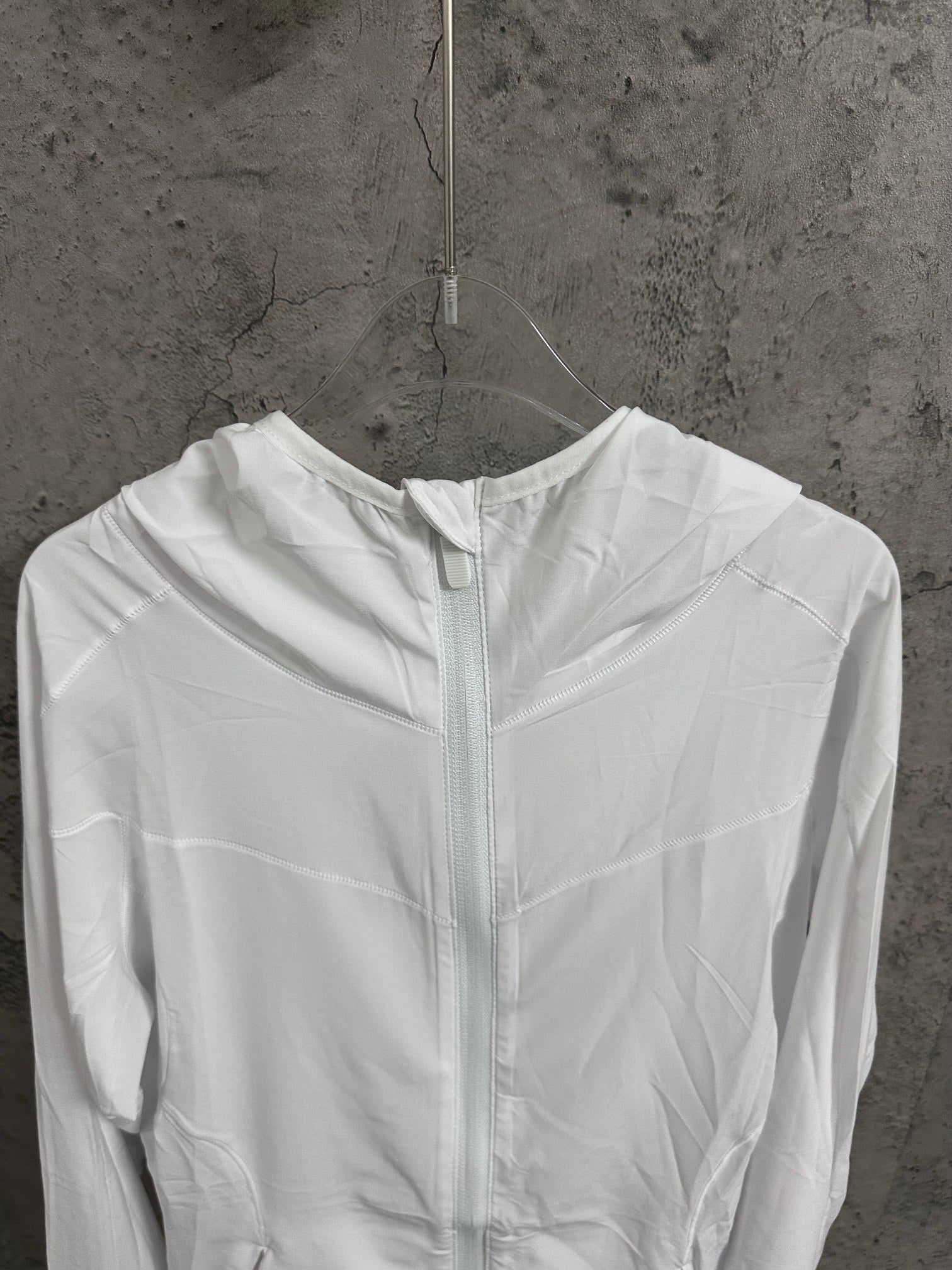 White hooded zip jacket front view with high collar